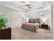 Spacious main bedroom featuring a tray ceiling, ceiling fan, and large windows with shutter blinds at 153 Witter Way, Woodstock, GA 30188