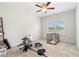This simple but functional bedroom features a work-out area, a window with natural light, and a pet carrier at 153 Witter Way, Woodstock, GA 30188