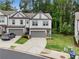 Gray two-story townhouse with a one car garage, concrete driveway and beautiful lawn at 153 Witter Way, Woodstock, GA 30188