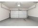 This is an empty garage with gray floors and white walls at 153 Witter Way, Woodstock, GA 30188
