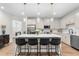 Modern kitchen with stainless steel appliances, central island with seating, and stylish pendant lights at 153 Witter Way, Woodstock, GA 30188