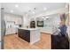 Open kitchen and living area with a center island, stainless appliances and white countertops at 153 Witter Way, Woodstock, GA 30188