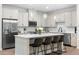 Modern kitchen with stainless steel appliances, a center island with seating, and stylish pendant lights at 153 Witter Way, Woodstock, GA 30188