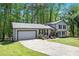 Inviting home featuring an attached garage and a freshly sealed driveway at 2022 Ramblewood Ne Ct, Marietta, GA 30062