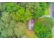 Aerial view showcasing the property with lush green trees surrounding the house at 2088 Blackberry Ln, Auburn, GA 30011