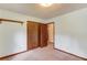 Bedroom with carpet, wood trim, double-door closet, and an open doorway at 2088 Blackberry Ln, Auburn, GA 30011