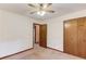 Carpeted bedroom featuring a ceiling fan and a window with wood trim at 2088 Blackberry Ln, Auburn, GA 30011