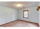 Cozy carpeted bedroom with textured ceiling and natural light from a wood-framed window at 2088 Blackberry Ln, Auburn, GA 30011