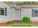 Close-up of the front door with green shutters, showcasing a tidy entrance and well-kept landscaping at 2088 Blackberry Ln, Auburn, GA 30011