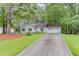 Charming one-story home featuring a well-manicured lawn and an extended driveway leading to an attached two-car garage at 2088 Blackberry Ln, Auburn, GA 30011