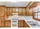 Traditional kitchen featuring wood cabinets, a white double-oven range, and stainless steel sink at 2088 Blackberry Ln, Auburn, GA 30011