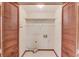 Laundry closet with bi-fold doors, shelving, and washer hookups at 2088 Blackberry Ln, Auburn, GA 30011