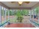 Enclosed porch with wooden floor and ceiling fan overlooking backyard at 2088 Blackberry Ln, Auburn, GA 30011