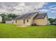 This backyard boasts a spacious lawn, a light yellow home exterior, and a cozy back patio at 3673 Jervis Ct, Rex, GA 30273