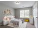 Bedroom with a queen-size bed, a window, and decor on shelves at 3673 Jervis Ct, Rex, GA 30273