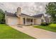 A cozy, light yellow home with a well-manicured lawn, attached garage, and inviting entrance at 3673 Jervis Ct, Rex, GA 30273