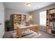 Home office with bookshelves and a wooden desk with laptop at 3673 Jervis Ct, Rex, GA 30273