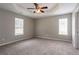 Large main bedroom with neutral tones, carpet and a tray ceiling at 3673 Jervis Ct, Rex, GA 30273
