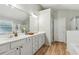The main bathroom features double sinks, a large mirror, a separate shower, and a soaking tub at 4266 Suwanee Brook Ct, Buford, GA 30518