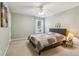 Cozy bedroom with neutral tones, a ceiling fan, and a window offering plenty of natural light at 4266 Suwanee Brook Ct, Buford, GA 30518