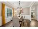 Bright dining room featuring a chandelier, wood floors, wainscoting and a large window with natural light at 4266 Suwanee Brook Ct, Buford, GA 30518