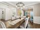 Bright dining room with wood floors, wainscoting and view of living room with comfortable seating at 4266 Suwanee Brook Ct, Buford, GA 30518