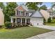 Charming two-story home featuring a welcoming front porch, two-car garage, and a well-manicured lawn at 4266 Suwanee Brook Ct, Buford, GA 30518