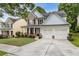 Well-maintained two-story home with a manicured lawn, featuring a two-car garage and classic architectural details at 4266 Suwanee Brook Ct, Buford, GA 30518
