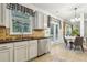 Well-lit kitchen with stainless steel appliances, tile backsplash and backyard access at 4266 Suwanee Brook Ct, Buford, GA 30518