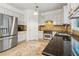 Modern kitchen featuring stainless steel appliances, tile floor and dark counters at 4266 Suwanee Brook Ct, Buford, GA 30518