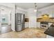Spacious kitchen with stainless steel refrigerator, granite counters and tiled floors at 4266 Suwanee Brook Ct, Buford, GA 30518