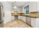 Well-appointed kitchen featuring tiled backsplash and stainless steel appliances at 4266 Suwanee Brook Ct, Buford, GA 30518