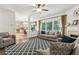 Open living room with fireplace and windows providing ample natural light, adjacent to the kitchen at 4266 Suwanee Brook Ct, Buford, GA 30518