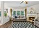 Living room with fireplace and large windows offering natural light, with access to the backyard at 4266 Suwanee Brook Ct, Buford, GA 30518