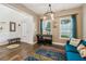 Inviting living space featuring hardwood floors, large windows, and a piano, perfect for entertaining guests at 4266 Suwanee Brook Ct, Buford, GA 30518