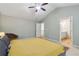 Main bedroom featuring a large vaulted ceiling, ceiling fan, and doorway leading to an en-suite bathroom at 4266 Suwanee Brook Ct, Buford, GA 30518
