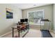 Bright office features a treadmill, a large window, and neutral colors for a productive workspace at 4266 Suwanee Brook Ct, Buford, GA 30518