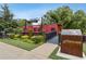 View of a red caboose with signage as part of an outdoor park exhibit with lush landscaping and walkways at 4266 Suwanee Brook Ct, Buford, GA 30518