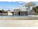 An eye-level view of a concrete architectural feature that includes a waterfall, seating, and tiered observation decks under a bright blue sky at 4266 Suwanee Brook Ct, Buford, GA 30518