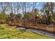 A sprawling wooden playground with slides and playhouses surrounded by trees, perfect for Gathering fun at 4266 Suwanee Brook Ct, Buford, GA 30518