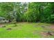 A green grass backyard with lots of green trees surrounding the property at 2045 Sherwood Se Dr, Marietta, GA 30067
