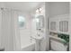 Classic bathroom with white fixtures, including a shower and tub combination, pedestal sink, and toilet at 2045 Sherwood Se Dr, Marietta, GA 30067