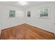 Inviting bedroom featuring hardwood floors, crisp white trim, and abundant natural light from multiple windows at 2045 Sherwood Se Dr, Marietta, GA 30067