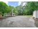 Wide shot of property showing large driveway, green trees and side of house at 2045 Sherwood Se Dr, Marietta, GA 30067