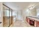 Primary bathroom featuring a tiled shower, soaking tub, double vanity with granite countertops, and decorative wall finish at 3642 Lake Estates Way Way, Atlanta, GA 30349