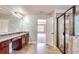 A bright bathroom featuring a granite countertop vanity and tiled shower with a glass door at 3642 Lake Estates Way Way, Atlanta, GA 30349