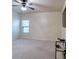 Carpeted bedroom featuring a ceiling fan and a television, offering a comfortable space for relaxation and entertainment at 3642 Lake Estates Way Way, Atlanta, GA 30349