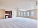 Spacious bonus room featuring a wet bar, ceiling fan, and multiple windows at 3642 Lake Estates Way Way, Atlanta, GA 30349