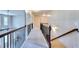 Long hallway with carpet, wrought iron railing, and arched doorways, offering an inviting transition between spaces at 3642 Lake Estates Way Way, Atlanta, GA 30349