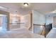 Upstairs hallway featuring carpet, wrought iron railing, and lots of natural light at 3642 Lake Estates Way Way, Atlanta, GA 30349